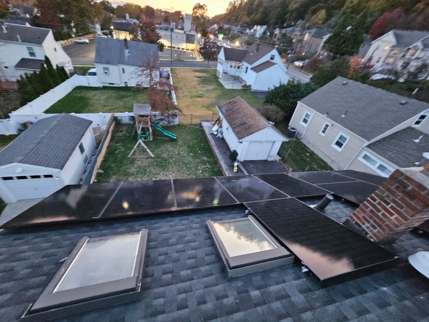 Aerial drone shot of a residential rooftop solar install with skylights