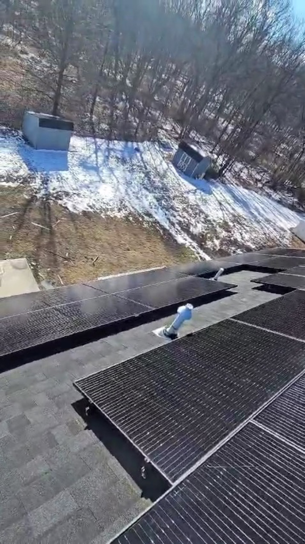 Reliant crew installing solar panels on a roof in winter