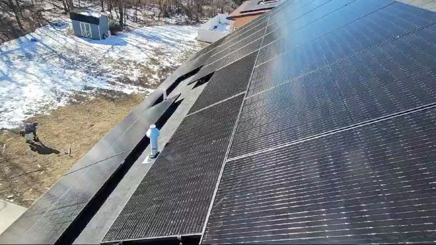Worker installing panels in the snow