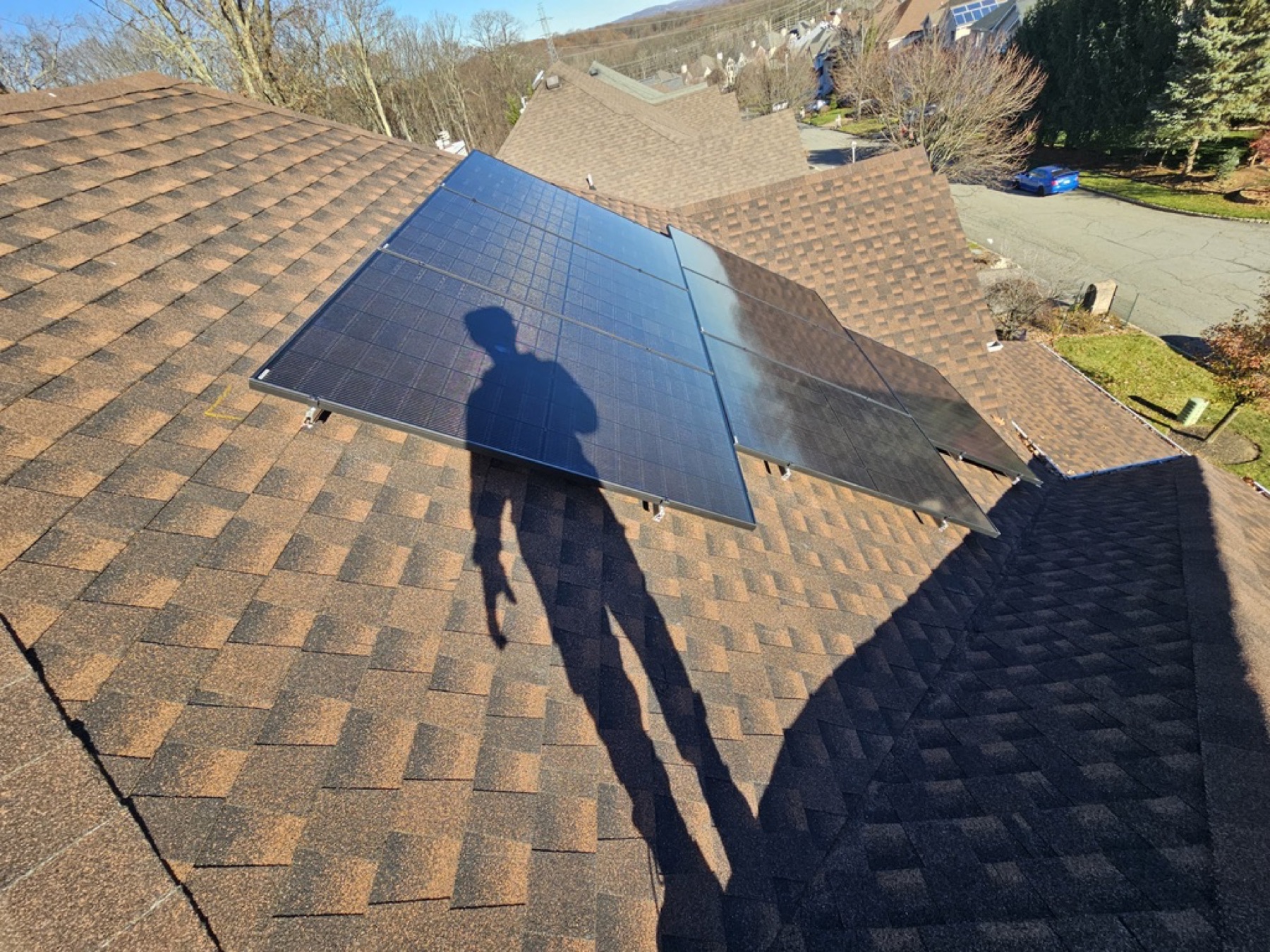 Reliant crew installing solar on a residential roof in autumn