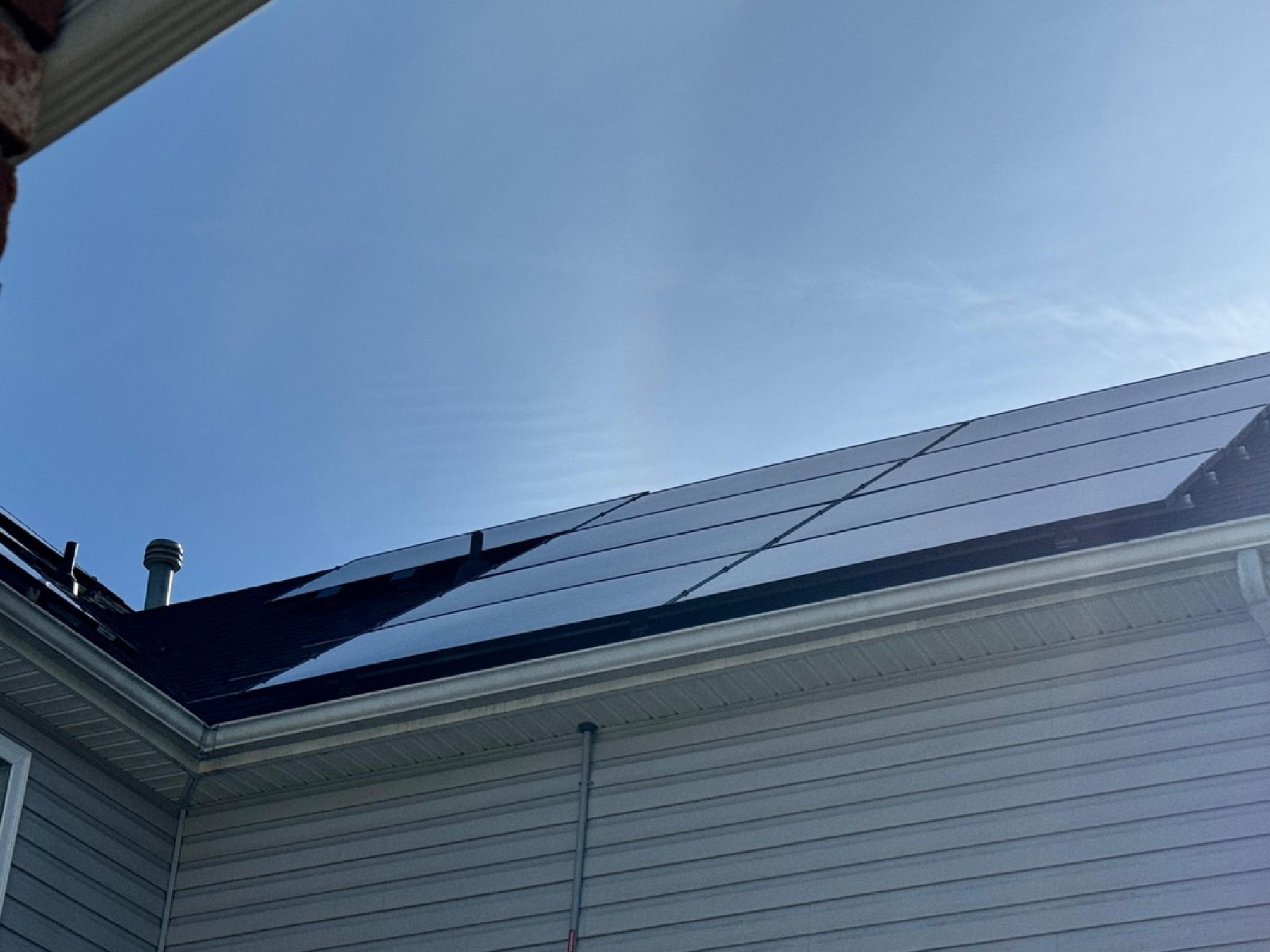 Low-angle shot of solar panels under dramatic clouds