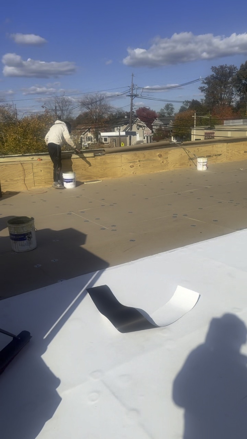 Commercial roof full tear-off and replacement in progress by Reliant Solar