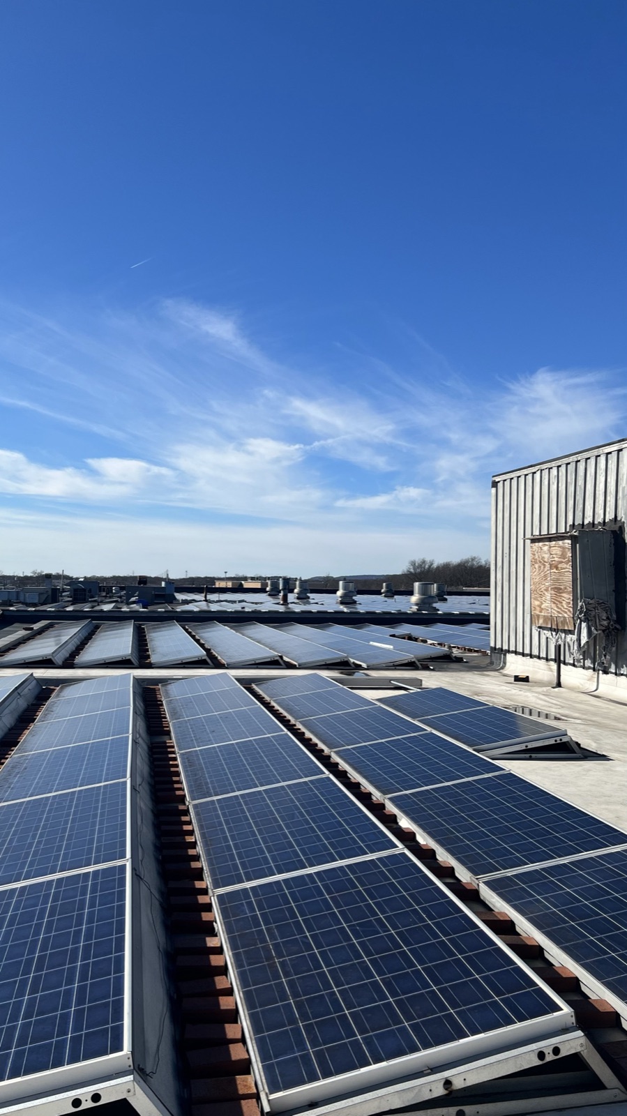 Commercial rooftop solar array on a flat warehouse roof installed by Reliant Solar