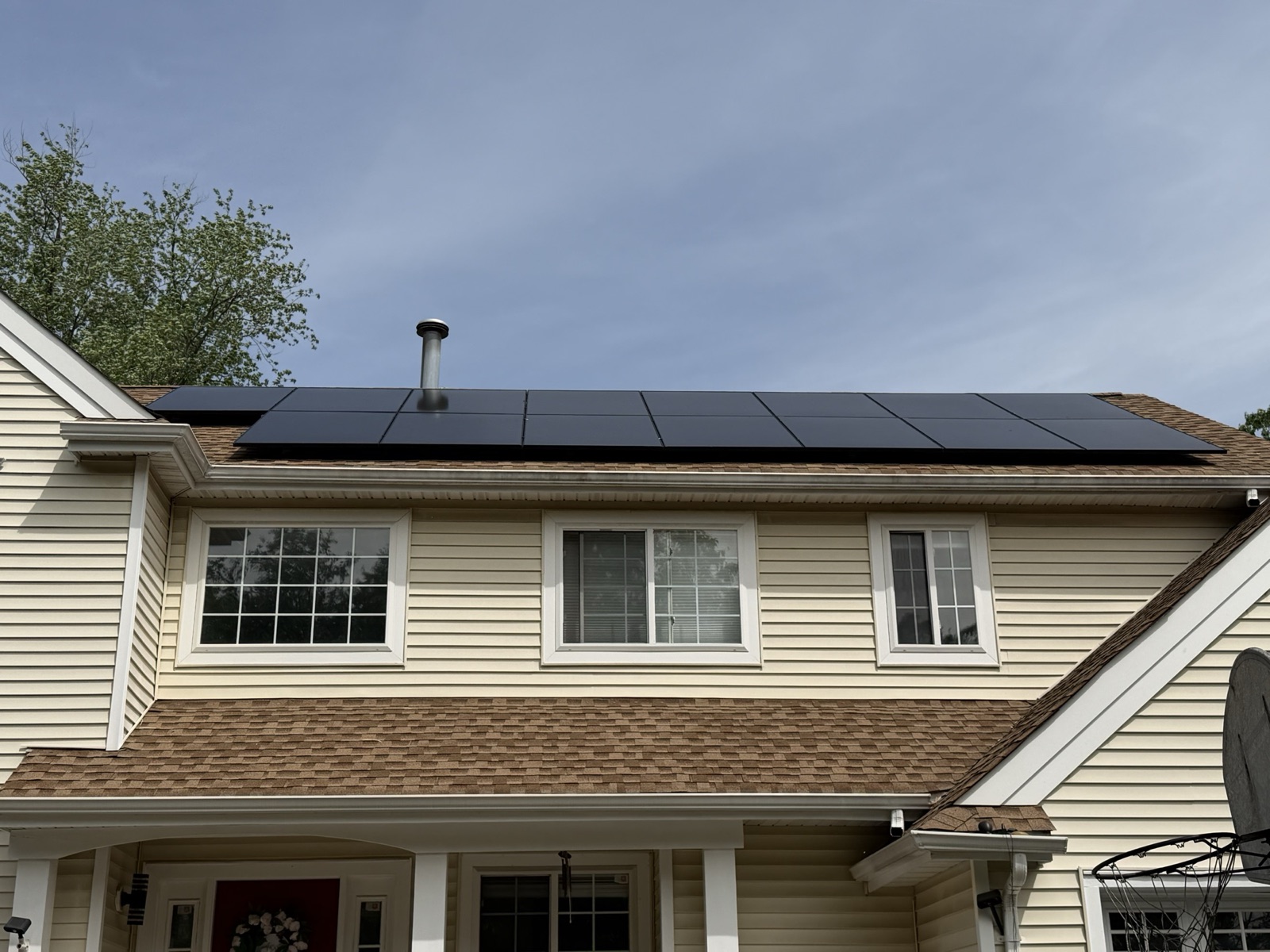 Completed residential home with a black solar panel array by Reliant Solar